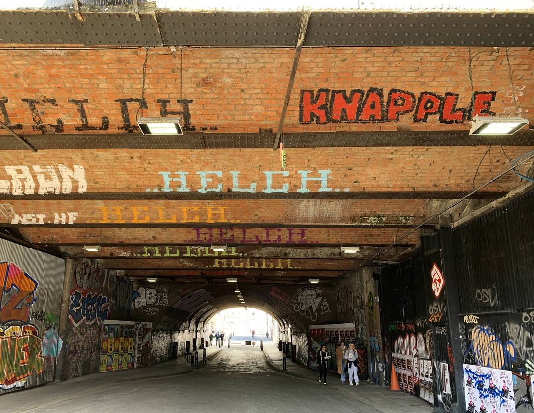 roller graffiti on brick lined tunnel roof in Shoreditch by Helch and Knapple