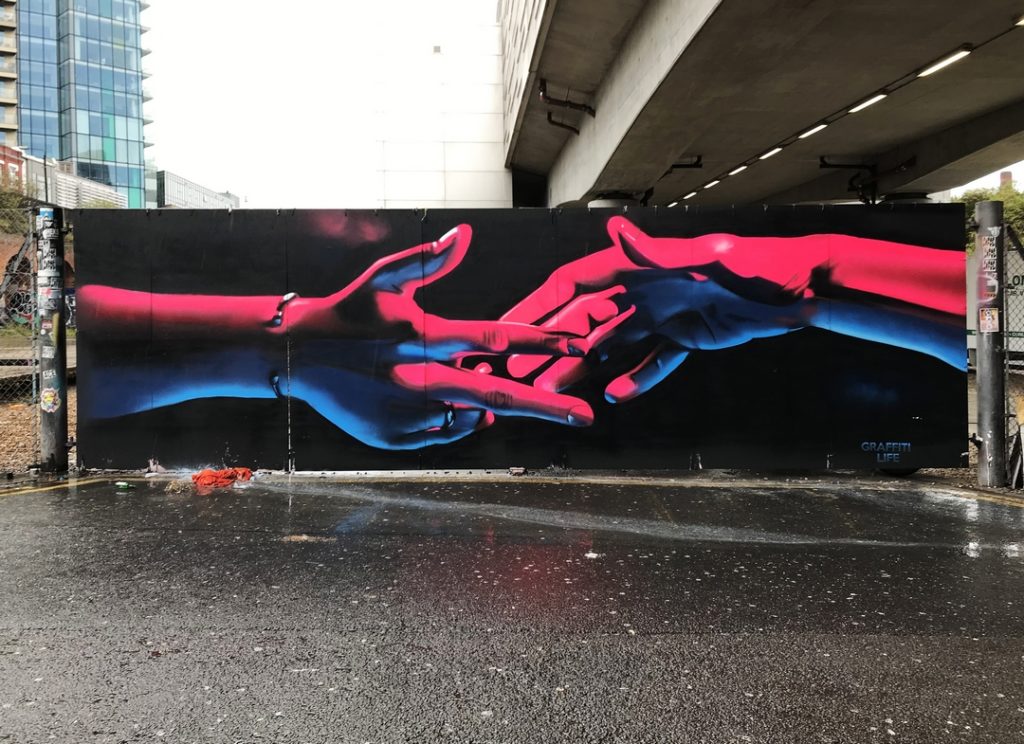 Pink neon "Creation of Adam" homage in Shoreditch painted by street artist David Speed