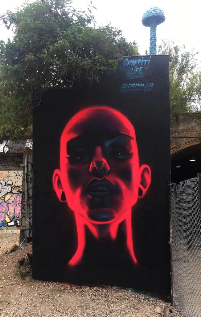 Pink neon street art spraypainted portrait of woman by David Speed