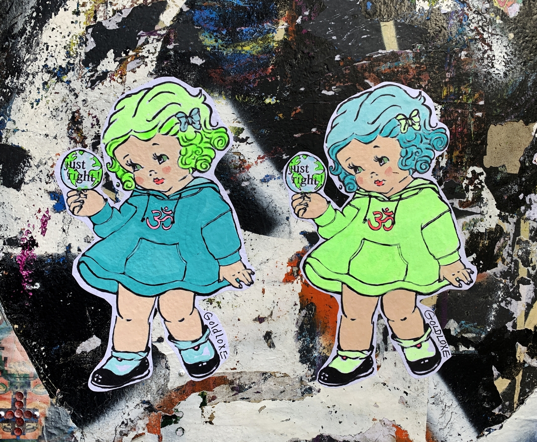 paste up street art of two Green eyed Girls on Brick Lane by Goldloxe