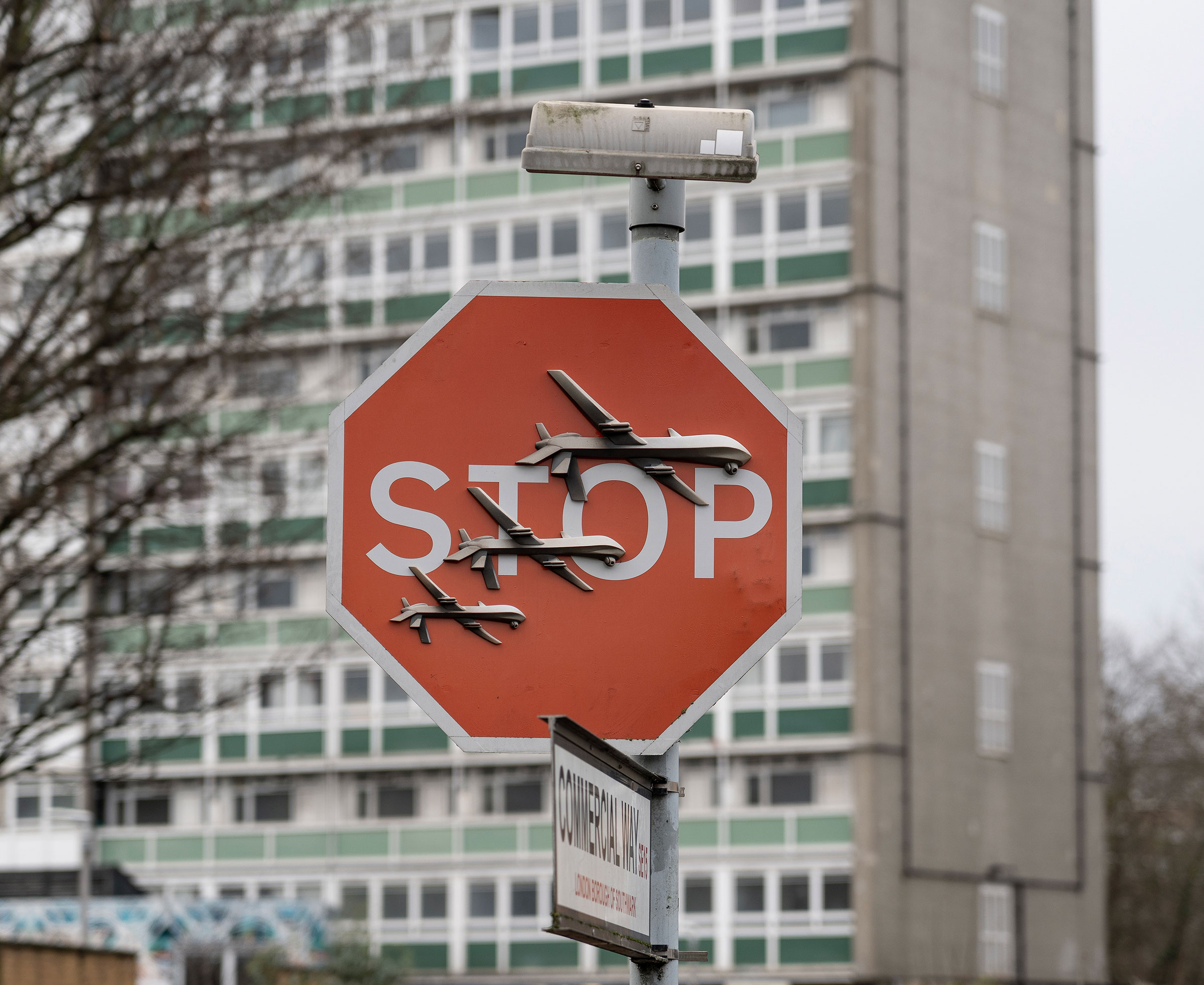 panoramic view of traffic STOP sign subverted by Banksy in Peckham