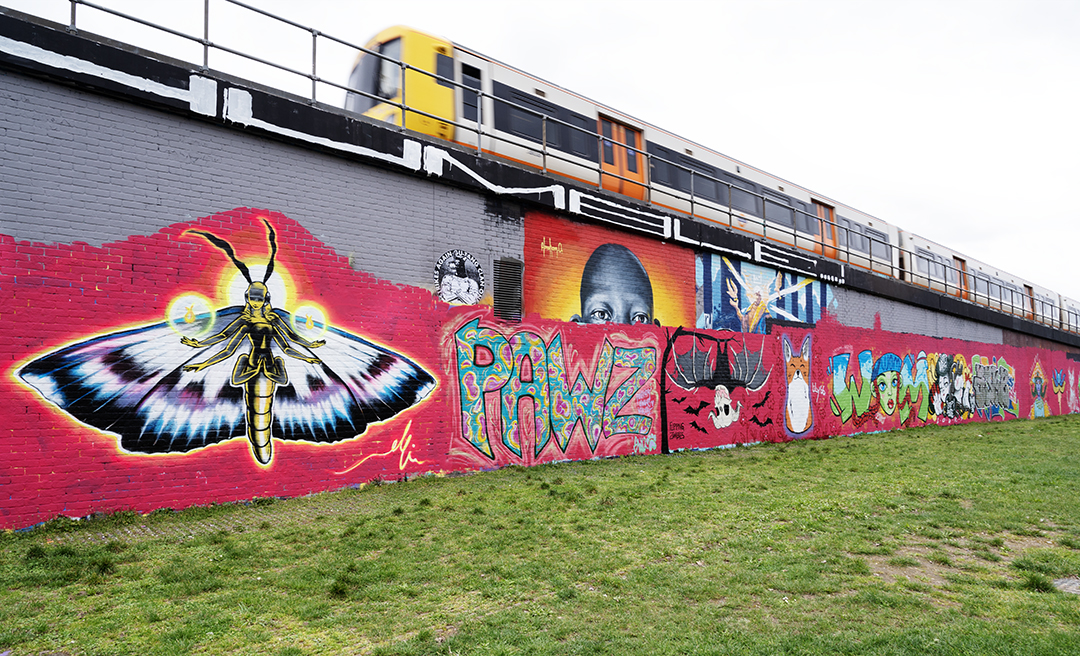 all female artists of WOM Collective painted a railway wall